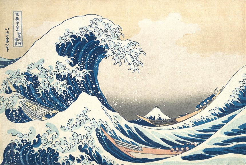 A woodblock print of a great wave over three boats, with Mount Fuji behind